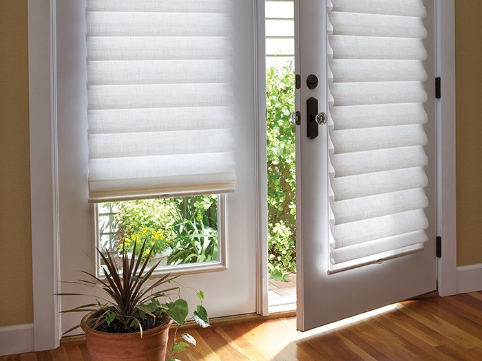 French doors with beautiful shades and oak wood floors